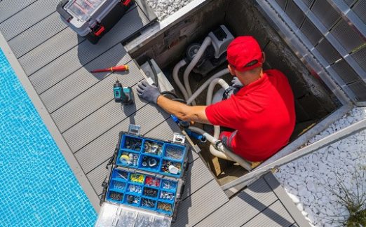 Outdoor Swimming Pool Cleaning and Heating Equipment Seasonal Maintenance Performed by SPA Professional Technician in His 40s